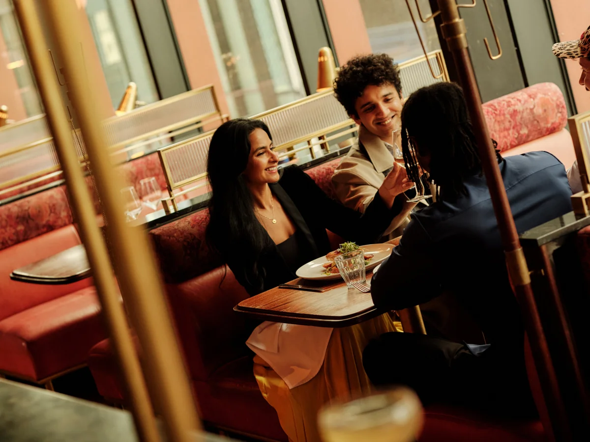 Friends dining at Ryleigh's Rooftop Steakhouse with city views